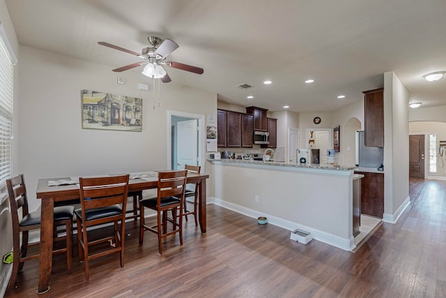 dining room featuring dark hardwood / wood-style flooring and ceiling fan