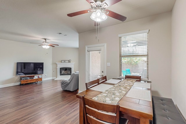 dining space with hardwood / wood-style floors and ceiling fan