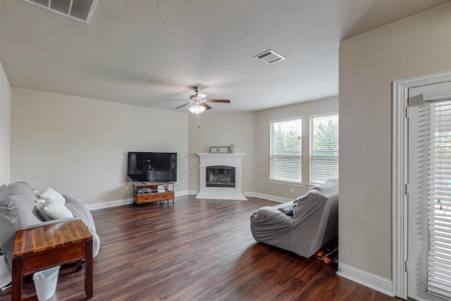 living room with dark hardwood / wood-style flooring and ceiling fan