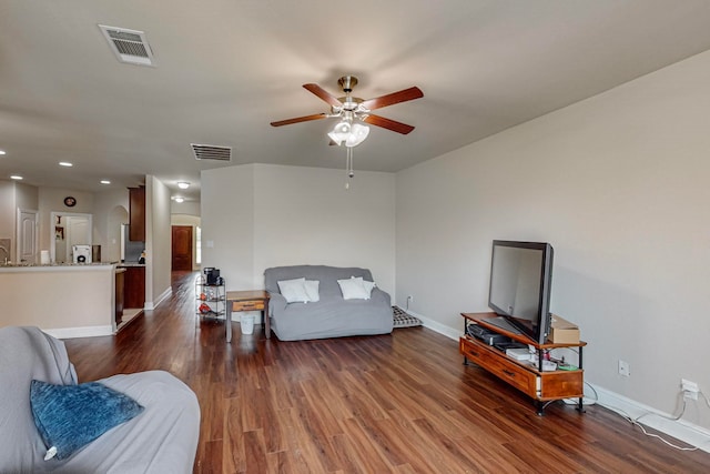 living room with ceiling fan and wood-type flooring