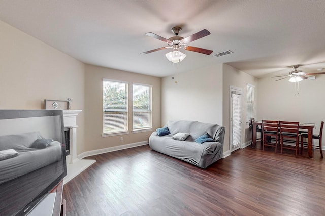 living room featuring dark hardwood / wood-style flooring and ceiling fan