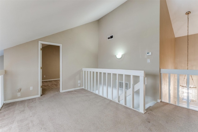 bonus room featuring light carpet and high vaulted ceiling