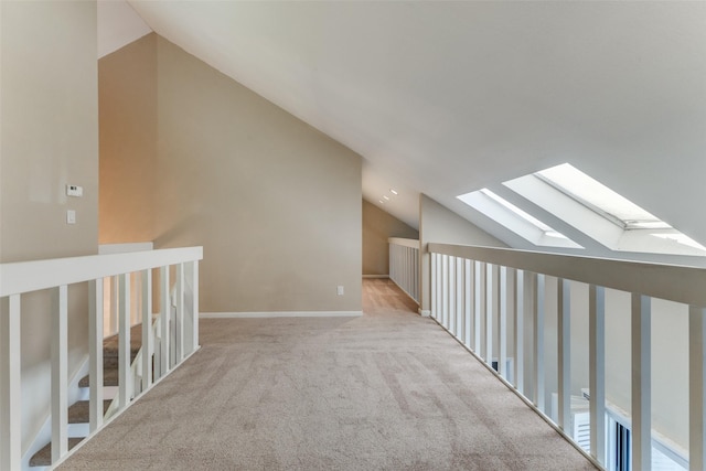 additional living space with light carpet and lofted ceiling with skylight