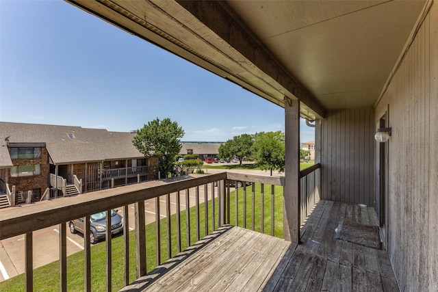 wooden terrace with a lawn