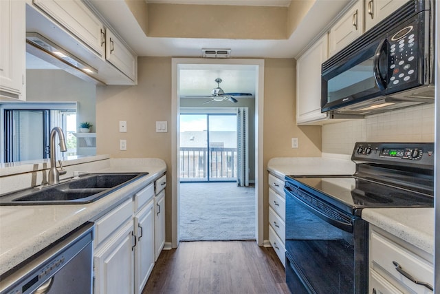 kitchen with white cabinets, black appliances, dark hardwood / wood-style flooring, sink, and ceiling fan