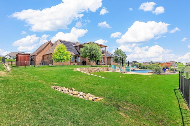 view of patio / terrace featuring ceiling fan, a fenced in pool, and an outdoor brick fireplace