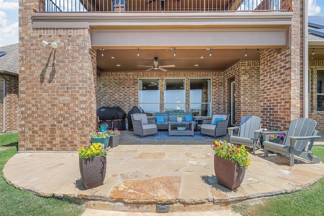 view of patio / terrace with ceiling fan, grilling area, a balcony, and an outdoor living space