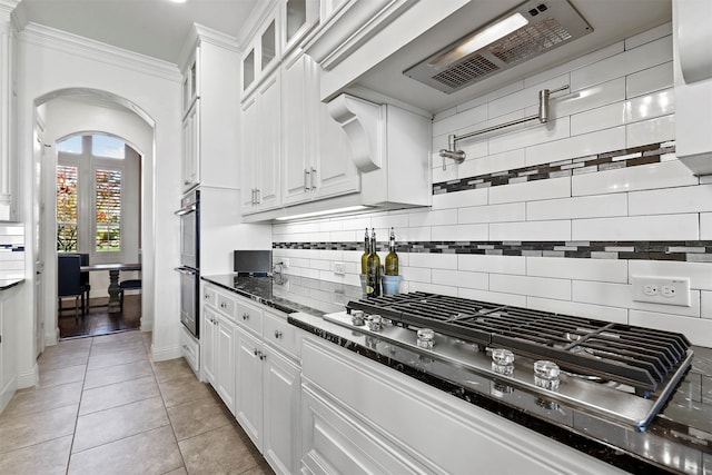 kitchen featuring an inviting chandelier, white cabinetry, light tile patterned floors, and decorative light fixtures