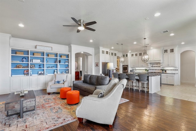 dining room featuring sink, ceiling fan, light tile patterned floors, and crown molding