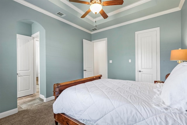 living room with a brick fireplace, light wood-type flooring, ceiling fan, and crown molding