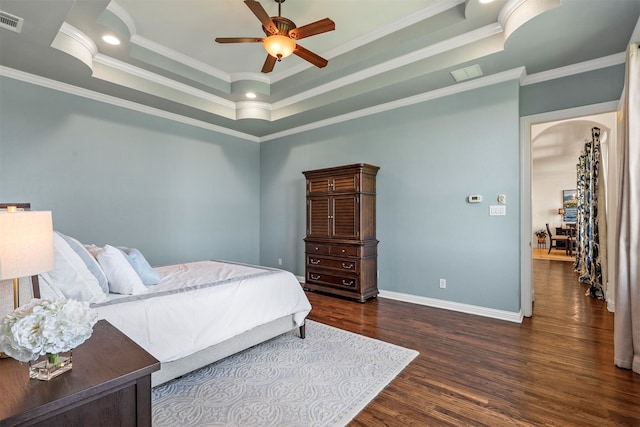 bedroom featuring ornamental molding, a raised ceiling, ceiling fan, and carpet floors