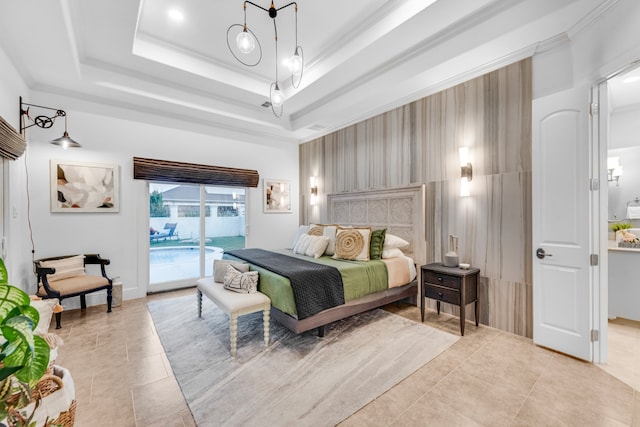 bedroom with light tile floors, access to outside, and a tray ceiling