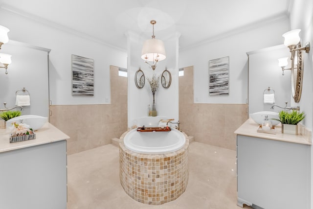 bathroom with tile walls, a washtub, tile floors, ornamental molding, and vanity