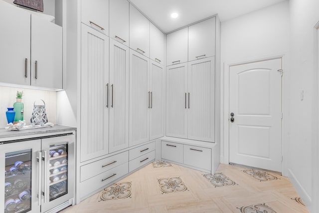 mudroom featuring wine cooler