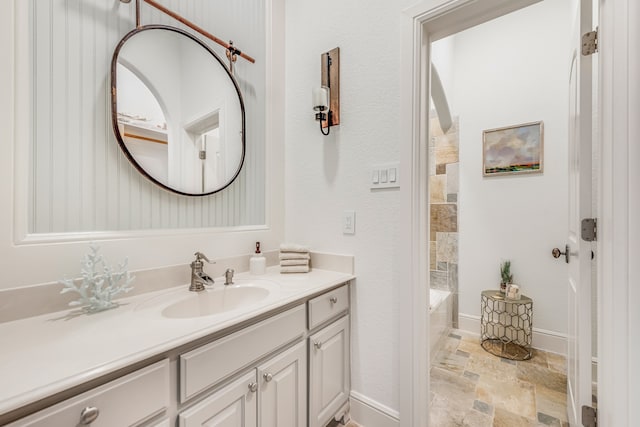 bathroom with vanity with extensive cabinet space, tile flooring, and a washtub