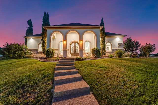 mediterranean / spanish-style home with a lawn