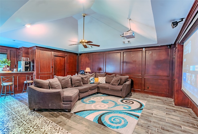 living room featuring lofted ceiling, ceiling fan, and light wood-type flooring