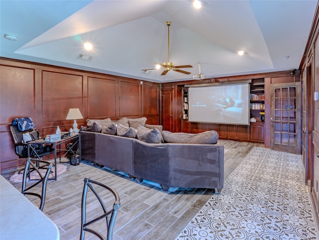 living room with ceiling fan and wooden walls