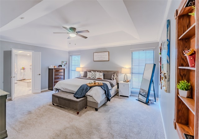 carpeted bedroom featuring ornamental molding, connected bathroom, ceiling fan, and a raised ceiling