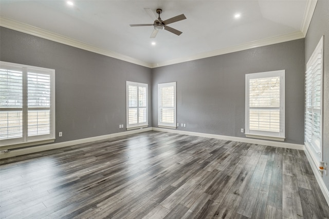 spare room featuring crown molding, dark wood-type flooring, and ceiling fan