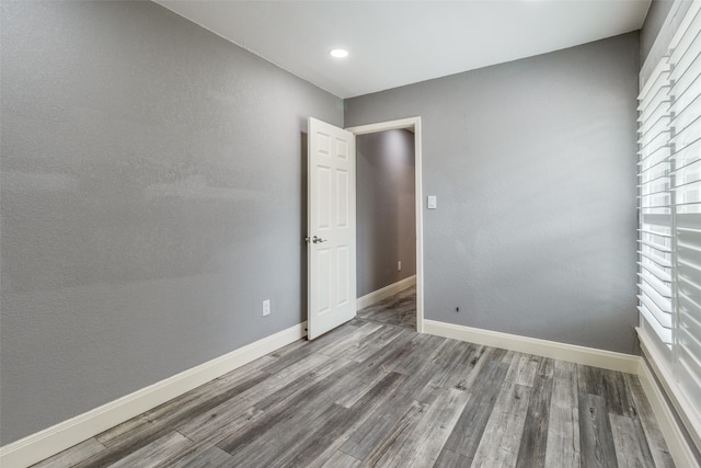 spare room with wood-type flooring