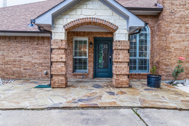 entrance to property featuring a patio