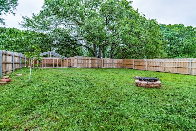 view of yard with an outdoor fire pit