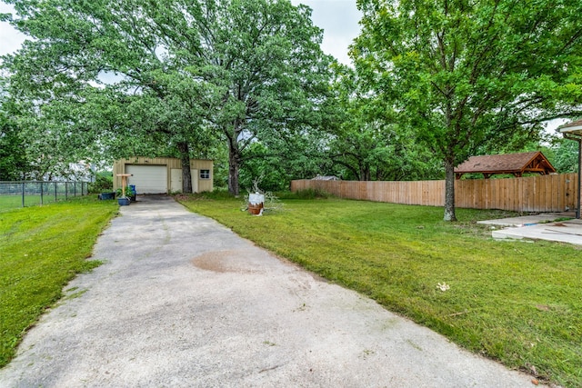 view of yard featuring a garage and an outdoor structure