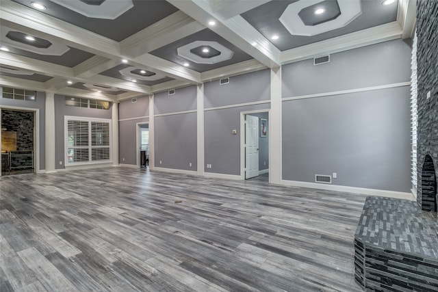 unfurnished living room with beam ceiling, hardwood / wood-style flooring, and coffered ceiling