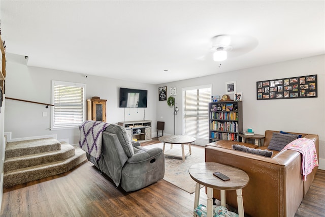 living room with ceiling fan and dark wood-type flooring