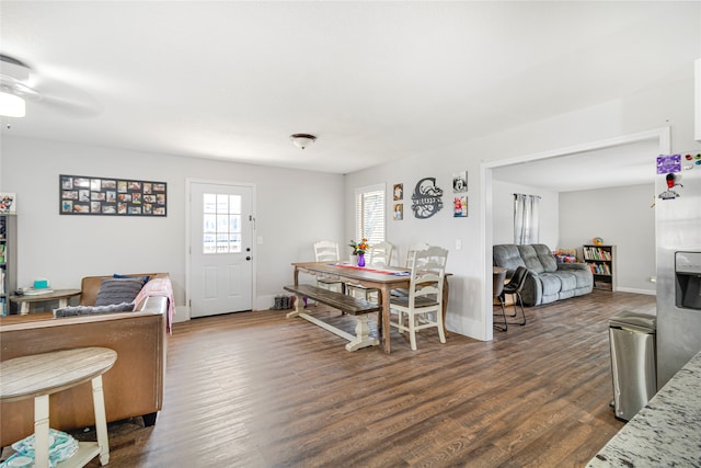 dining area featuring ceiling fan and dark wood-type flooring