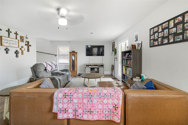 living room with wood-type flooring and ceiling fan