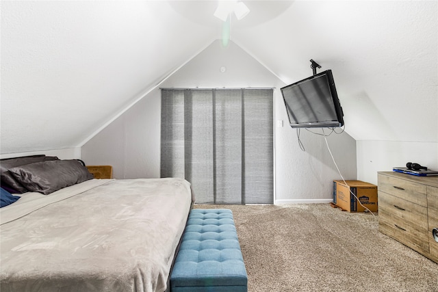 bedroom with lofted ceiling, ceiling fan, and carpet flooring