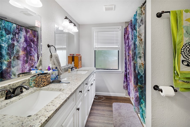 bathroom featuring hardwood / wood-style flooring and double sink vanity