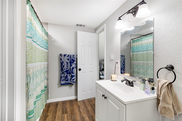 bathroom with hardwood / wood-style floors and vanity