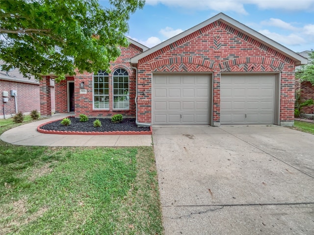 view of property featuring a garage and a front lawn