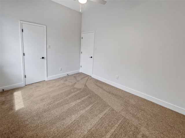 empty room featuring ceiling fan and carpet floors