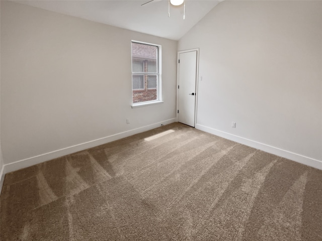 carpeted spare room with lofted ceiling and ceiling fan