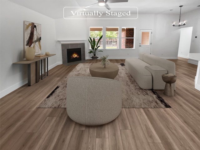 living room with a tile fireplace and hardwood / wood-style floors