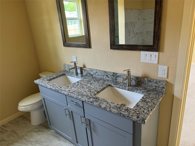 bathroom with tile floors, dual bowl vanity, and toilet