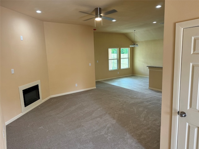 unfurnished living room with carpet, ceiling fan, and vaulted ceiling