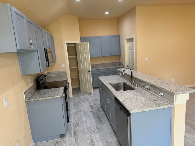 kitchen with appliances with stainless steel finishes, sink, light tile floors, and light stone countertops