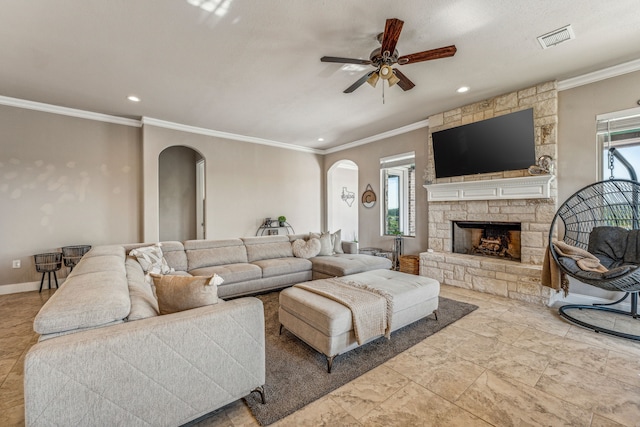 living room featuring a stone fireplace, a healthy amount of sunlight, ceiling fan, and tile floors