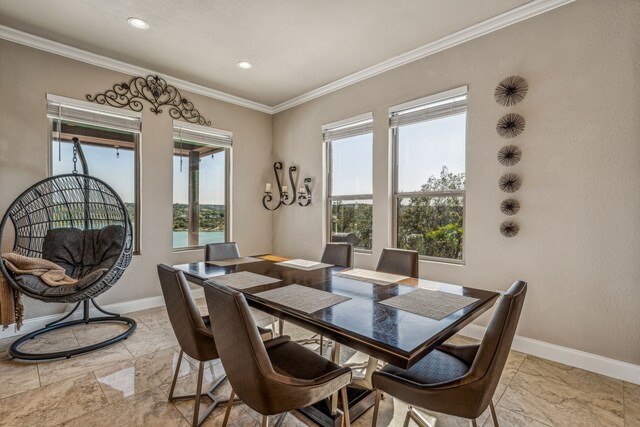 tiled dining space featuring crown molding