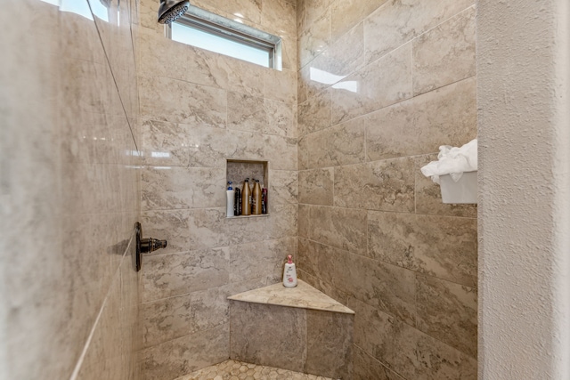 bathroom with a tile shower