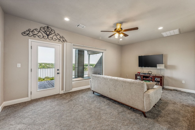 carpeted living room featuring ceiling fan