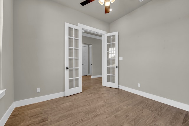 spare room with ceiling fan, light wood-type flooring, and french doors