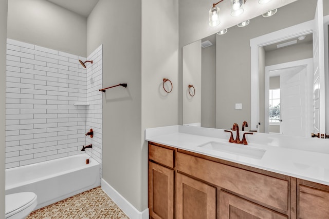 full bathroom featuring vanity, tile patterned floors, tiled shower / bath, and toilet