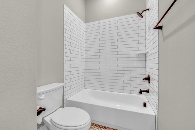 bathroom featuring tiled shower / bath and toilet