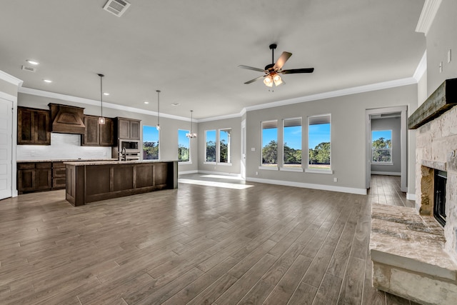 living room featuring a fireplace, hardwood / wood-style flooring, and ornamental molding